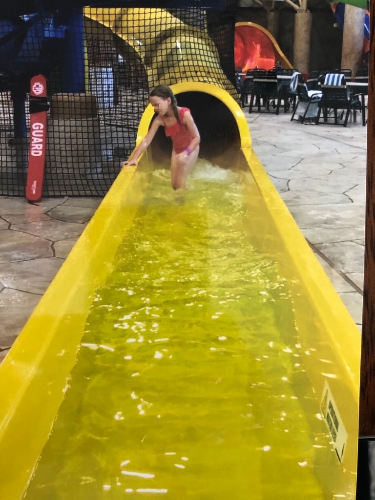 Great Wolf Lodge girl getting off tunnel slide