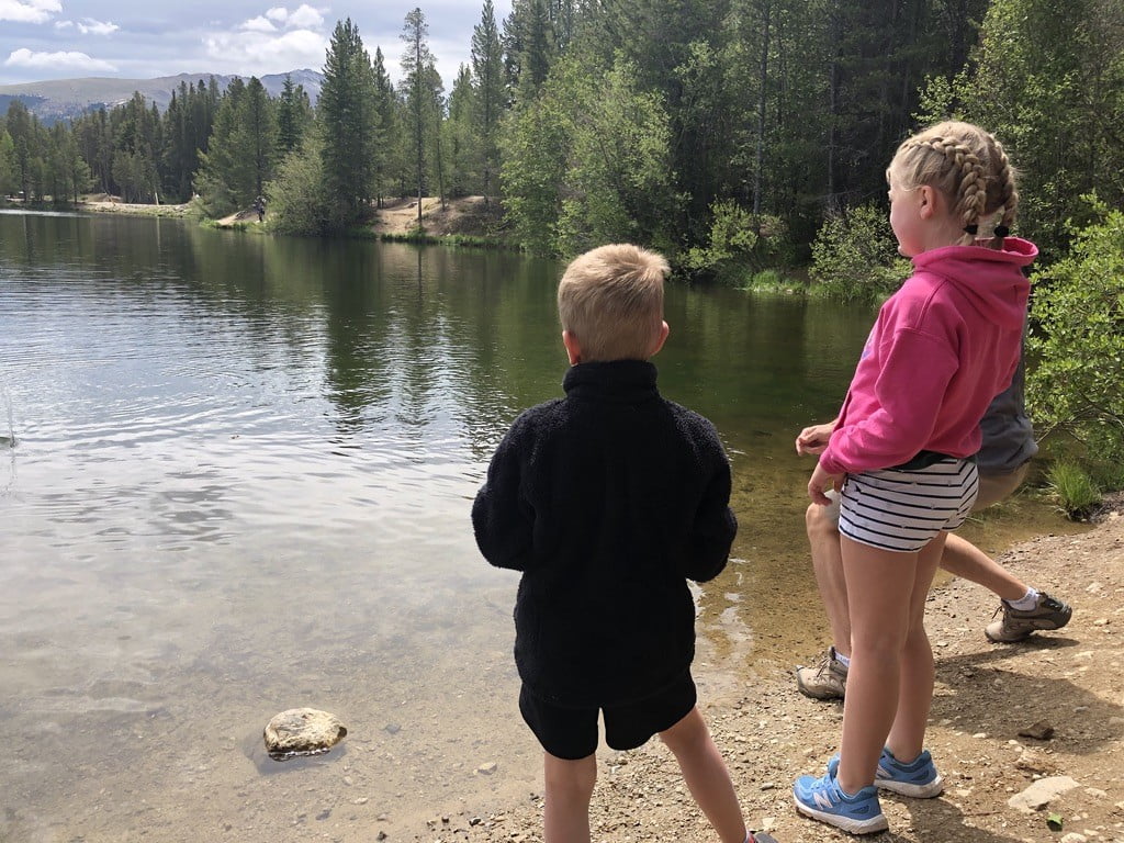 boy standing at lake