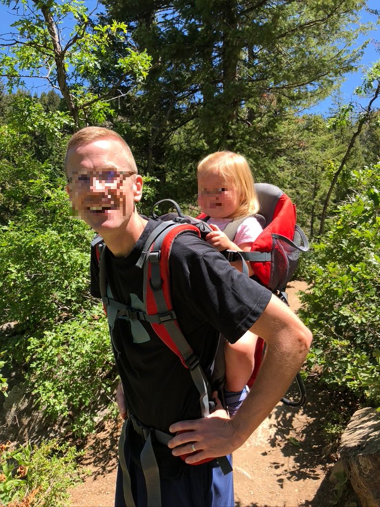 dad carrying daughter on back
