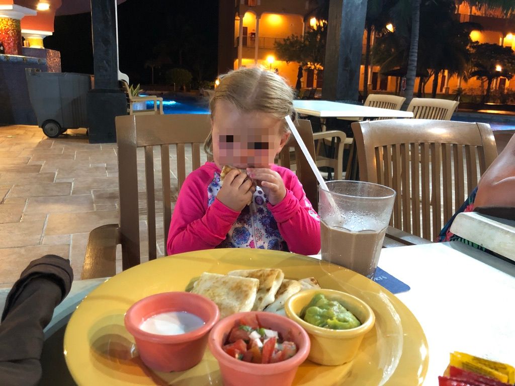 girl eating quesadilla at Royal Haciendas
