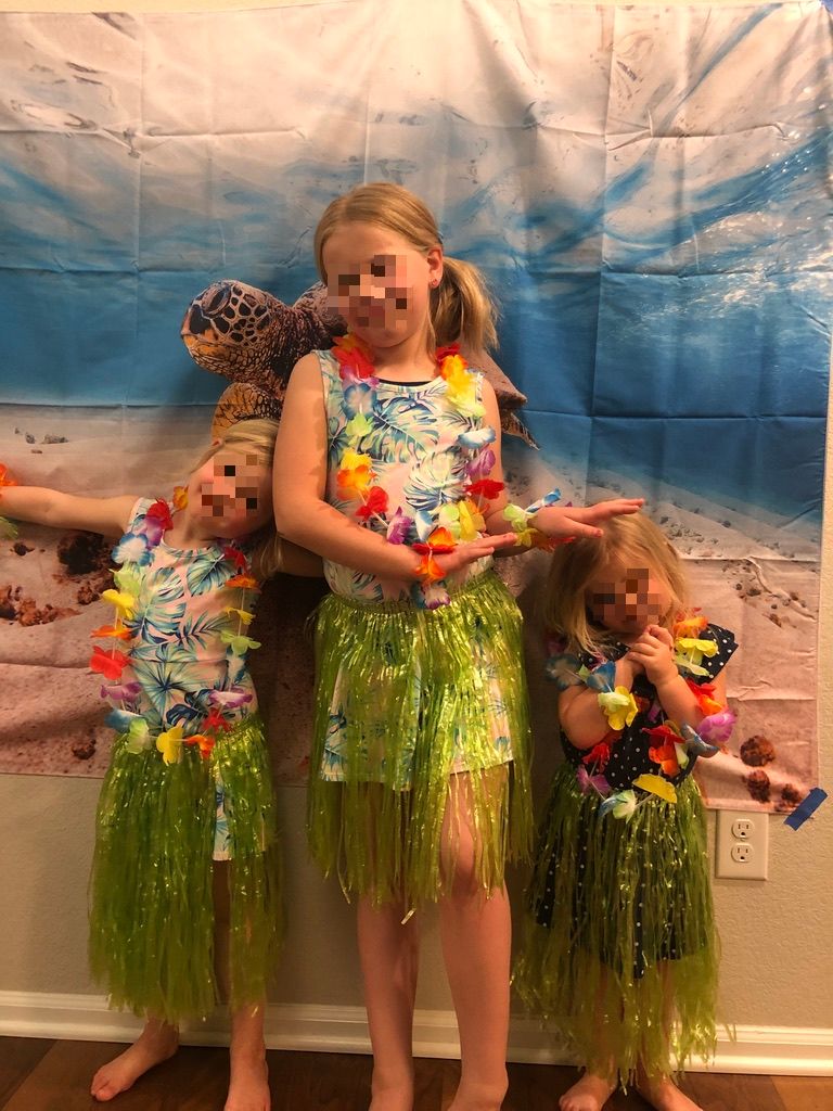 girls doing the Hula for Hawaiian Day at home