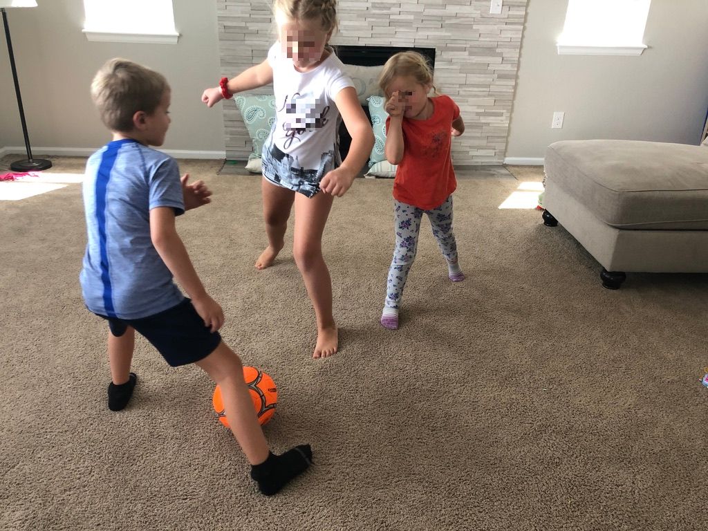 kids playing soccer in the living area