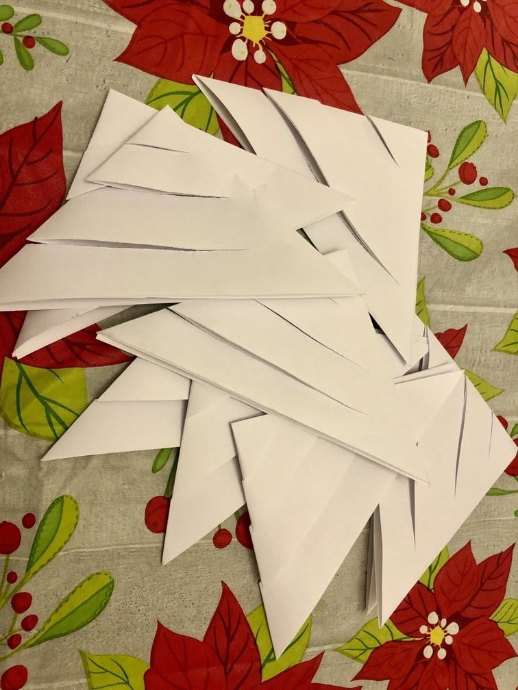multiple cut folded papers for how to make a giant paper snowflake