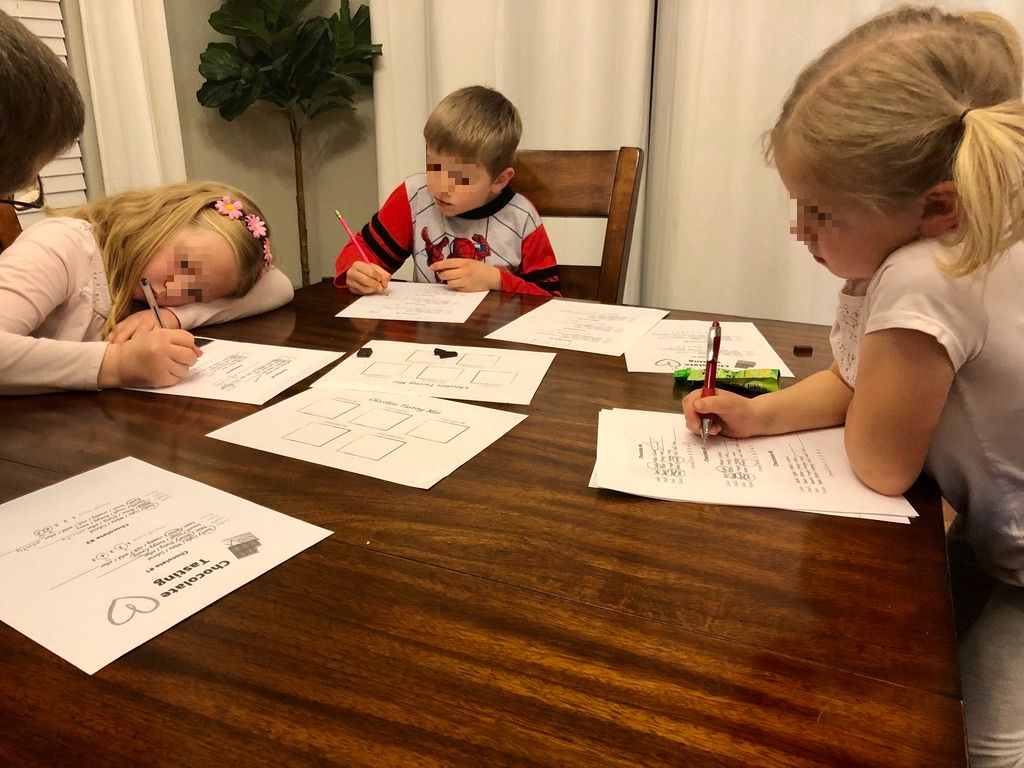 kids writing notes for the Chocolate tasting at home