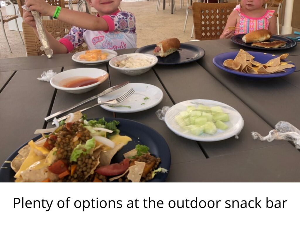Viva Wyndham Maya snacks.  Kids eating at an outdoor table