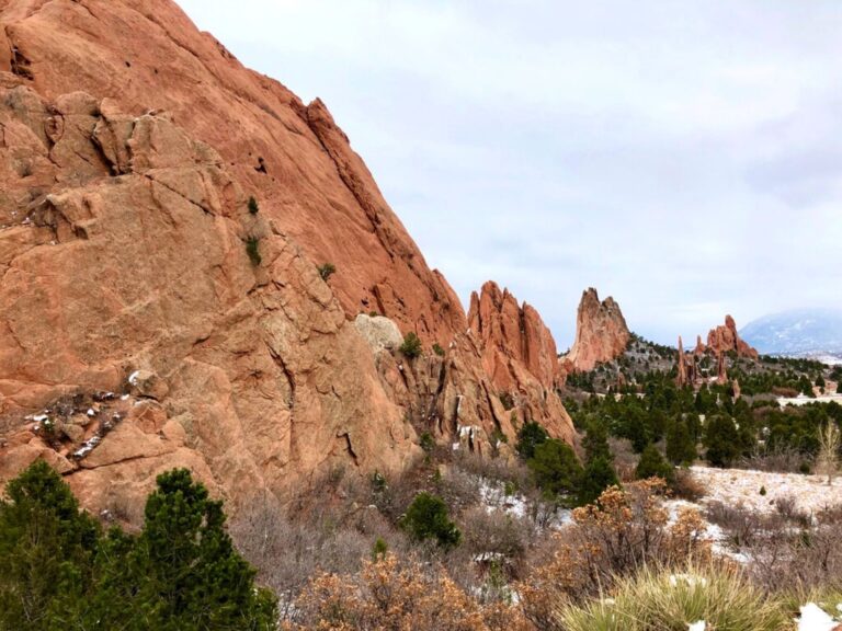 Garden of the gods large red rock formation with dusting of snow and grayish blue skies