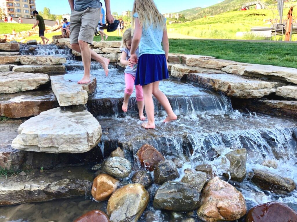 kids playing in the creek near Steamboat Grand