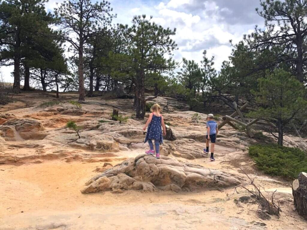 kids hiking over rocks in Roxborough State Park