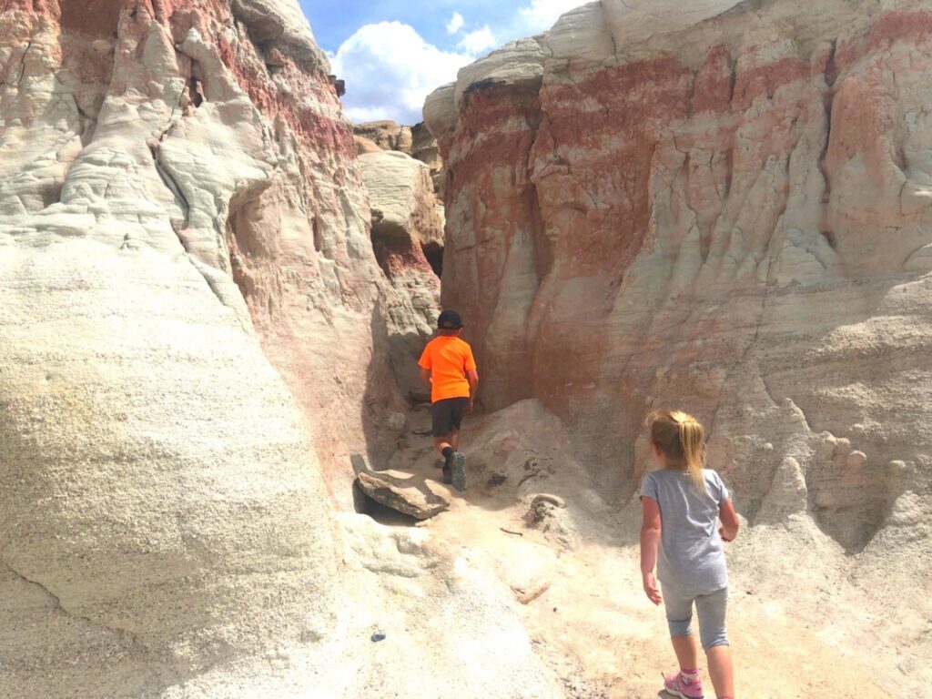 kids walking through white and red rock formations