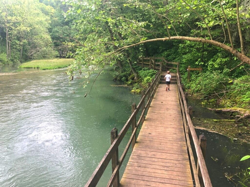 boy running on wooden bridge on Spring Trail in Ha Ha Tonka State Park