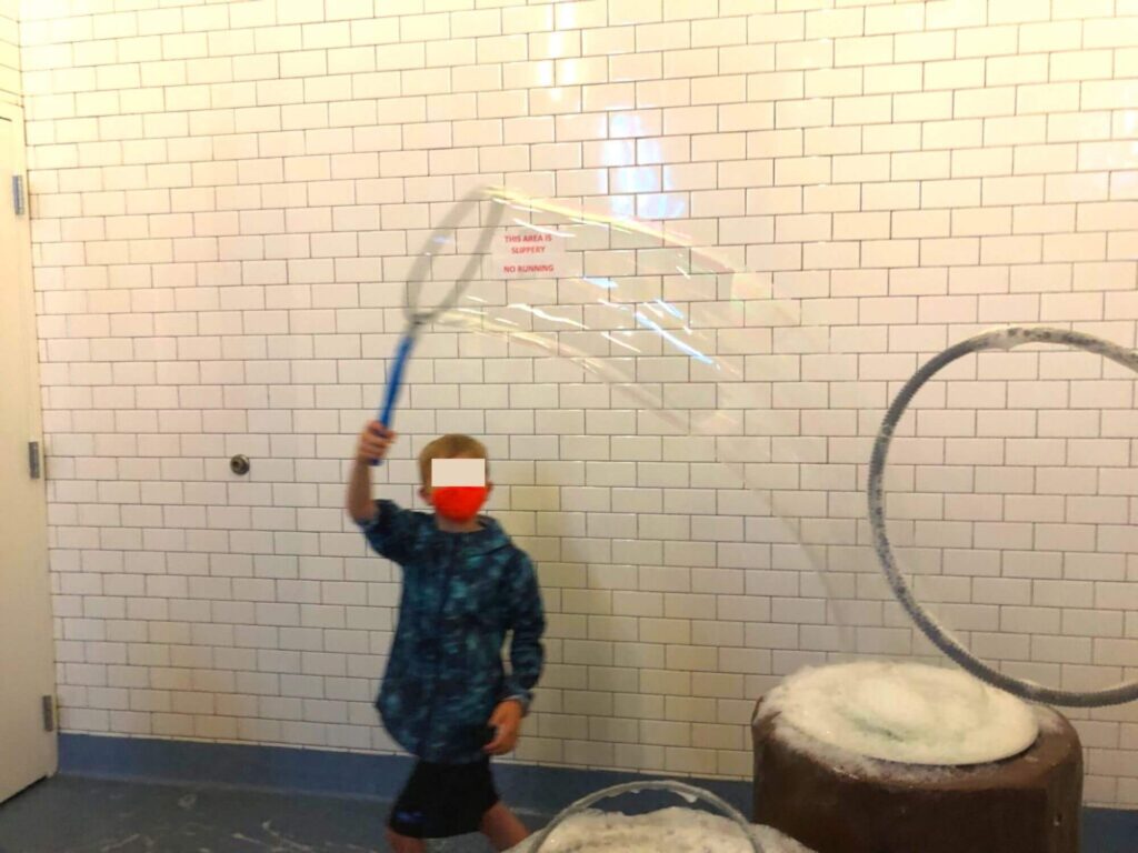kid making huge bubbles