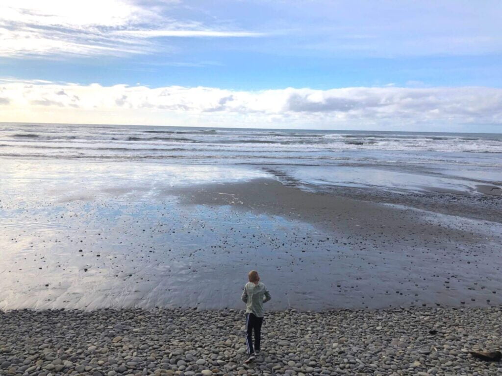 boy watching the tide on Beach 1 in Olympic National Park
