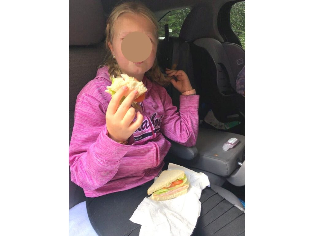girl eating a turkey sandwich