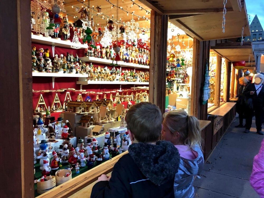 Kids looking at Christmas items at Christkindl market in Denver, CO