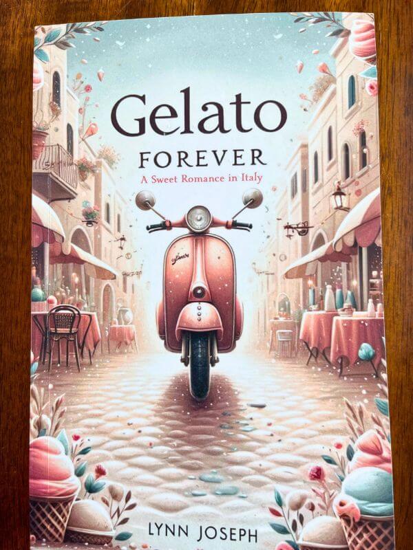 Cover of "Gelato Forever," a book based in Italy. A graphic of a pink moped on a light beige cobblestone street. Pastel pink colored buildings line the side of the street