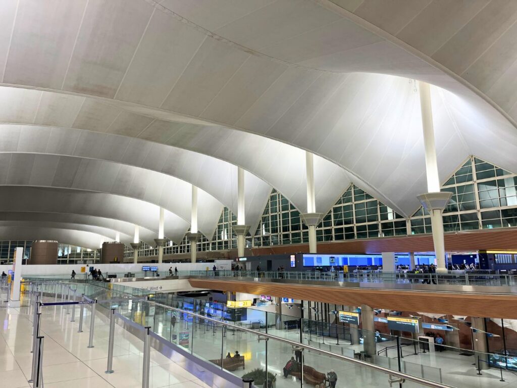 Denver airport early in the morning.  The Jeppesen/main terminal has a ceiling trying to replicate snowy mountains