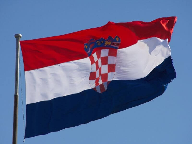 Croatia flag with three thick horizontal stripes of red, white, and blue. A red and white checkerboard shield is in the middle.