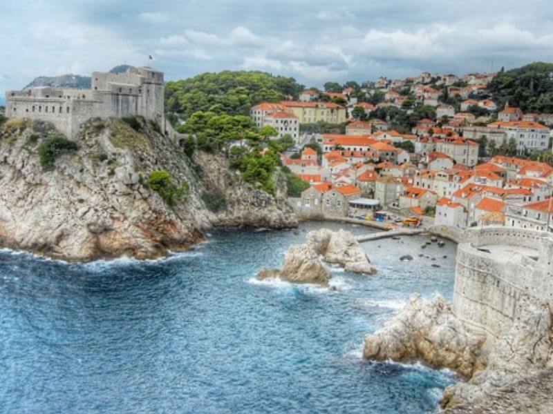 orange top buildings lining the bay of the rocky coast in Dubrovnik
