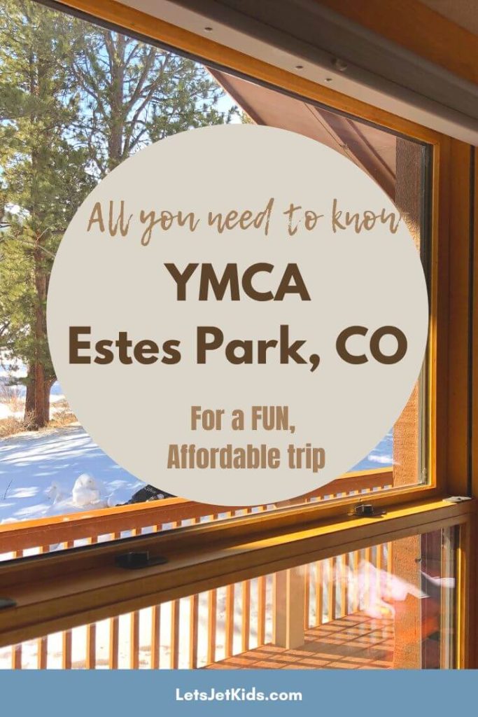 looking out a cabin window onto a snow covered ground on a sunny day with text overlay "all you need to know YMCA Estes Park, CO for a fun affordable trip"