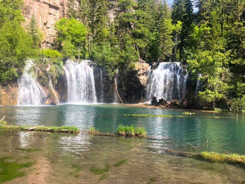turquoise lake with 3 waterfalls
