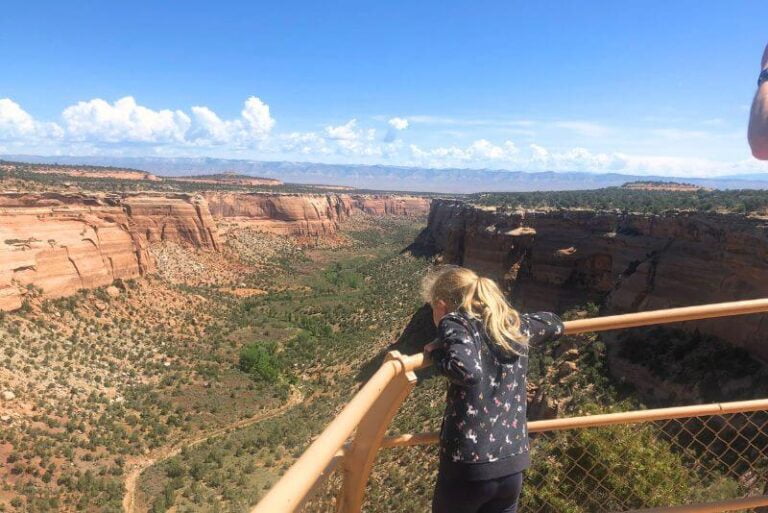 girl looking over rail at Colorado National Monument