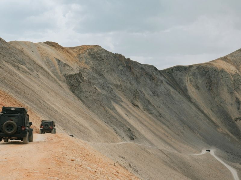 jeeps on a barren mountain road
