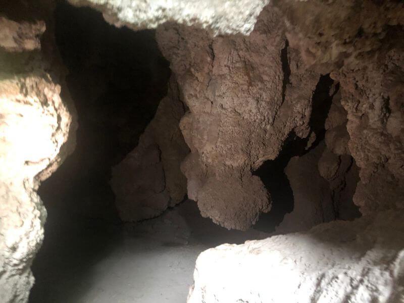 inside a small cave at Rifle Falls State Park, low rock walls