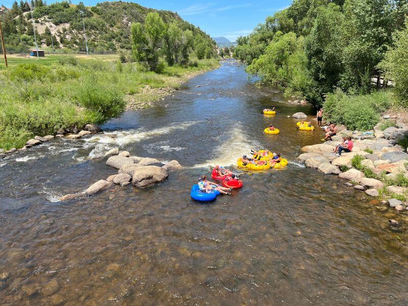 large innertubes floating down a river in Steamboat Springs in Summer