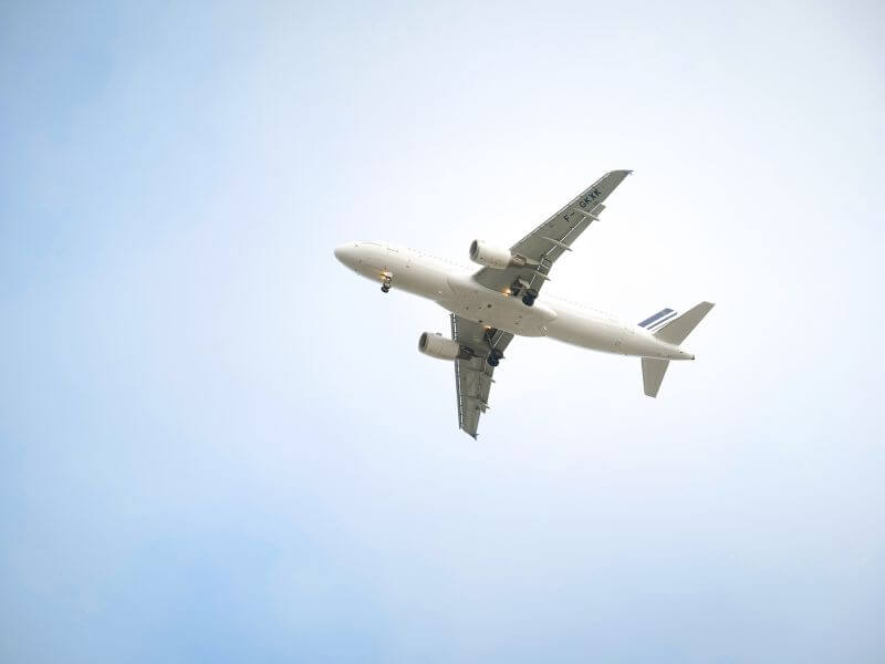zoomed in on an airplane surrounded by sky, taking an airplane is one way to get from the Denver airport to Aspen