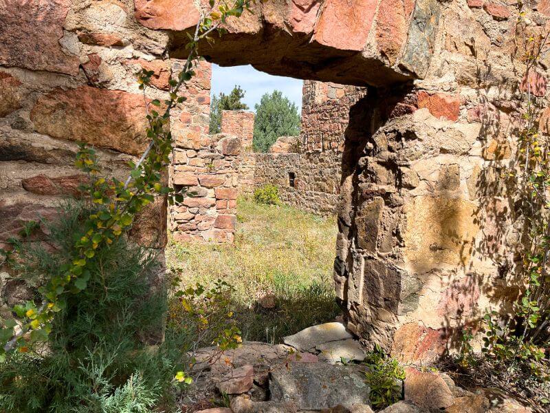 looking through a stone window without glass outside at Mount Falcon Park