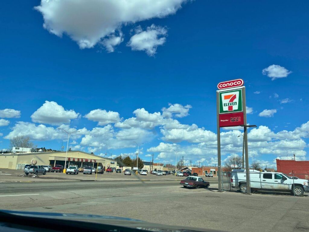 tall 7-11 sign on road, safeway grocery store across the street