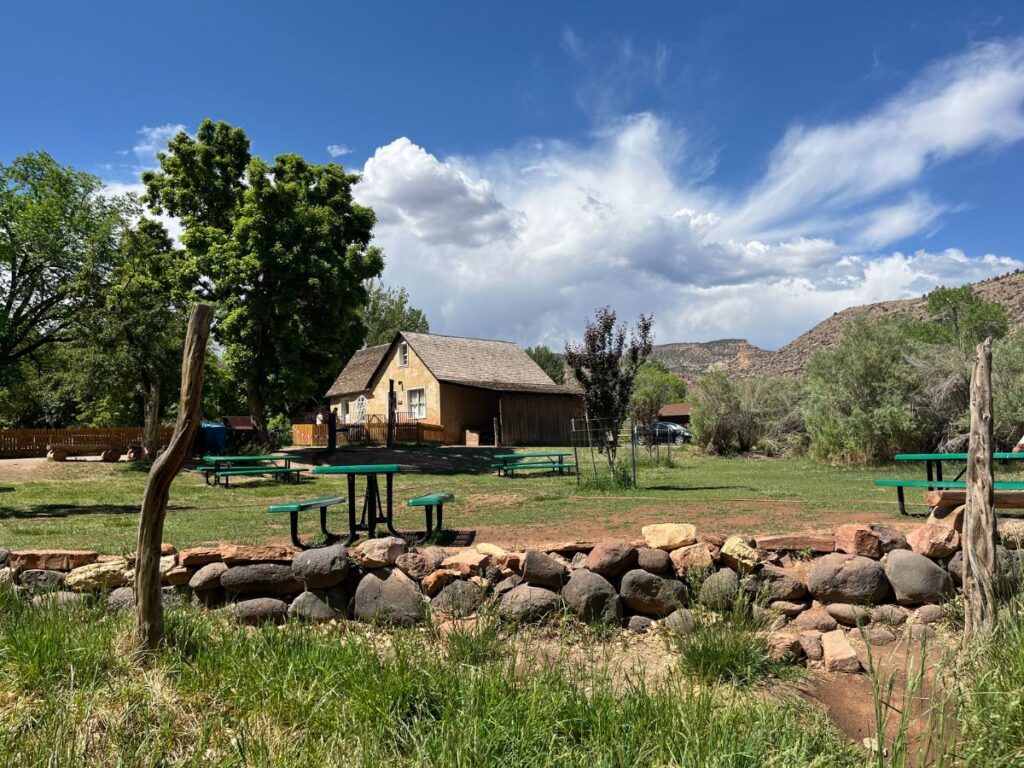 the gifford house store, a historic home in a grassy area with a few picnic tables at Capitol Reef