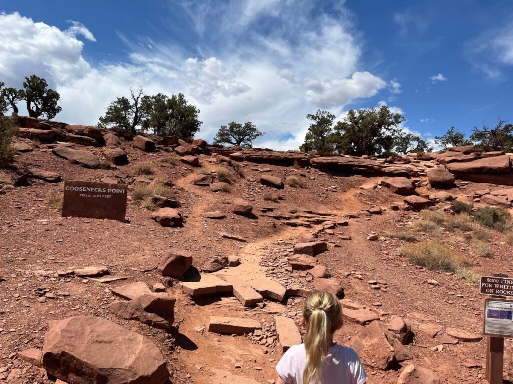 trailhead to goosenecks trail in Capitol Reef. Red rocky ground leads the trail up