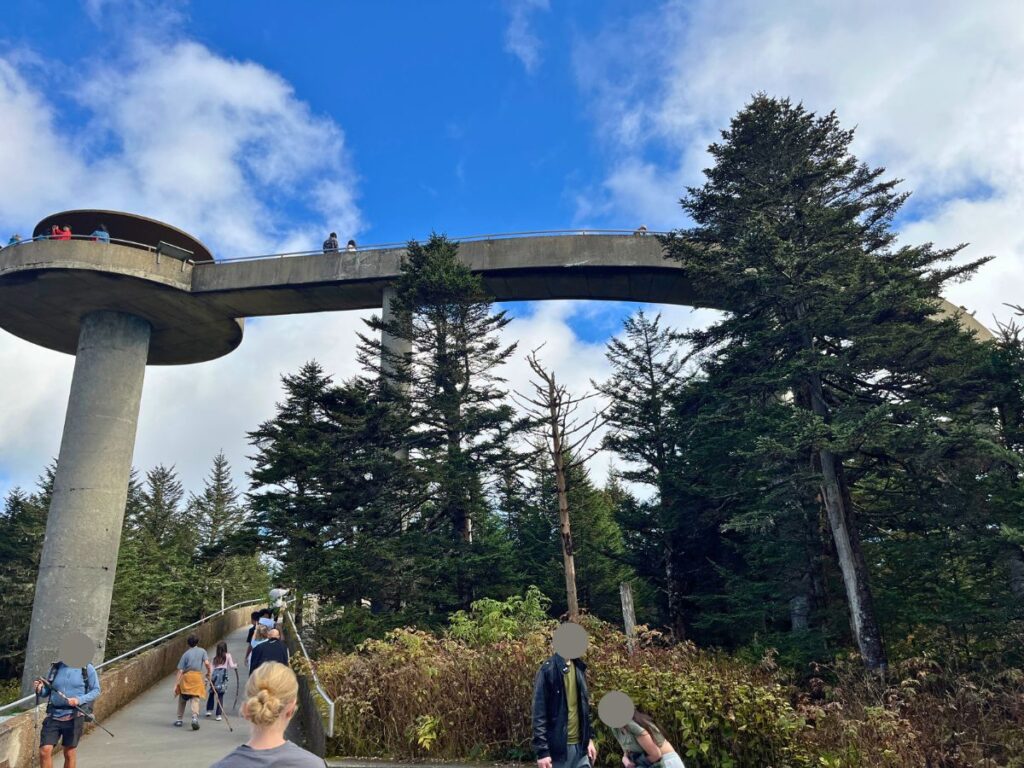 a tall cement lookout tower with a path winding down from the top at Kuwohi Great Smoky Mountains