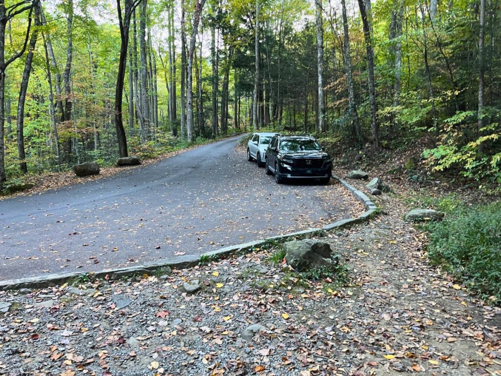 The parking area for the Baskins Creek Falls trailhead is a wide, pullover area on the Roaring Fork Motor NAture Trail in Great Smoky Mountains