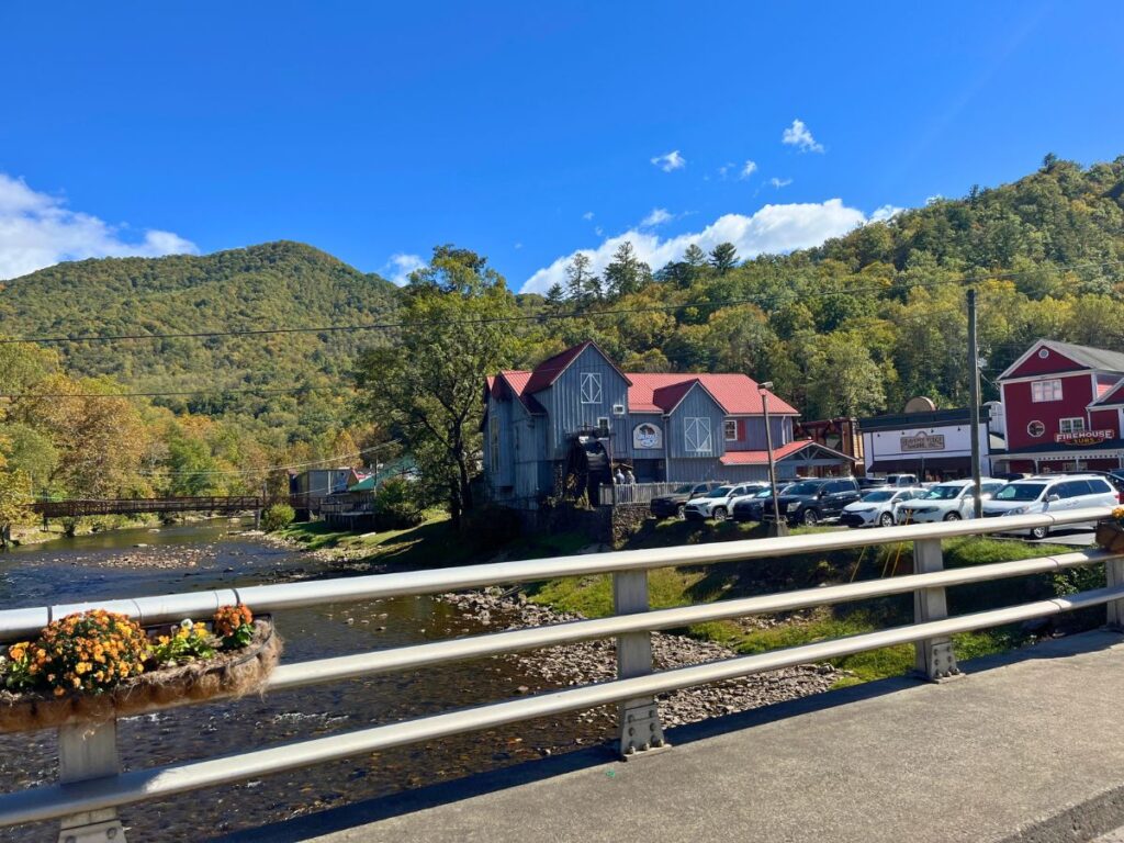 looking over metal rails on the road to a little quaint shopping area and mill in Cherokee North Carolina