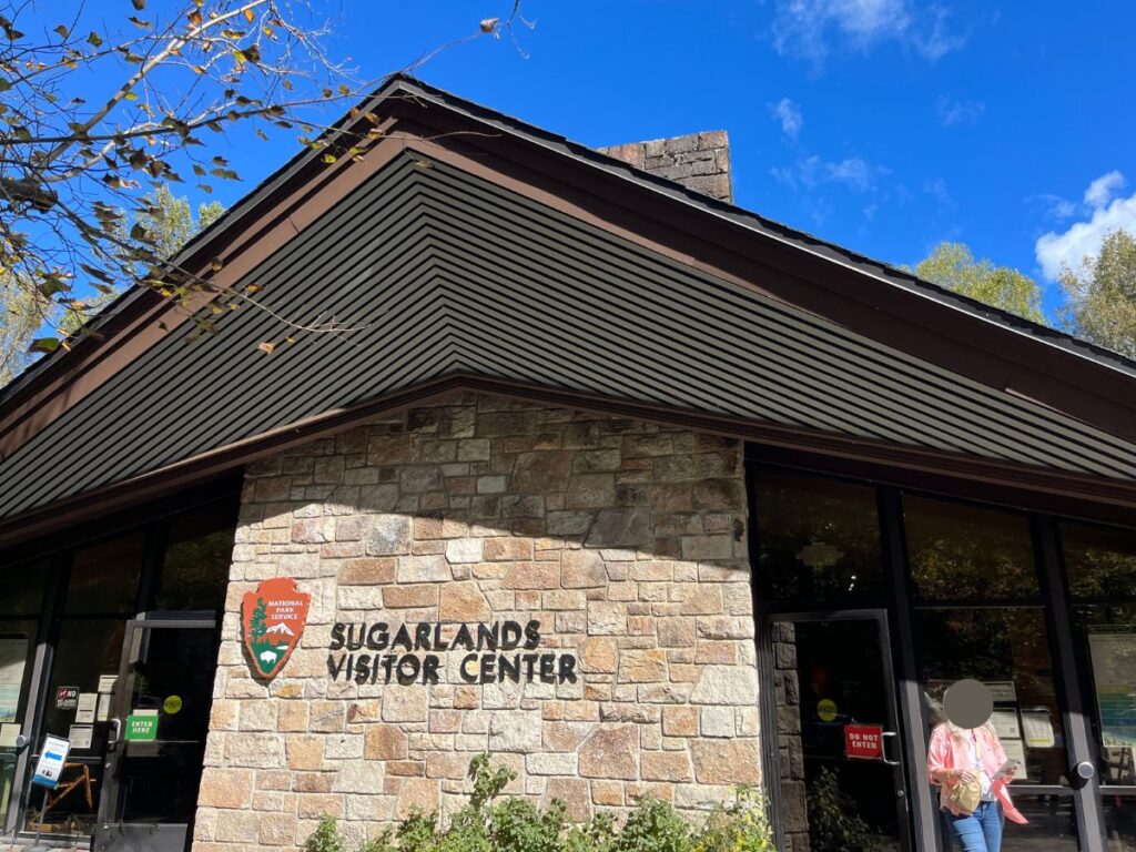 sugarlands visitor center at Great Smoky Mountains National Park is a building with a stone front and a-framed roof